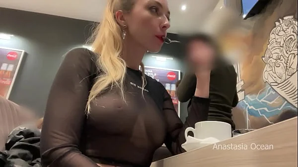 Flashing her big boobs in transparent top in public cafe.