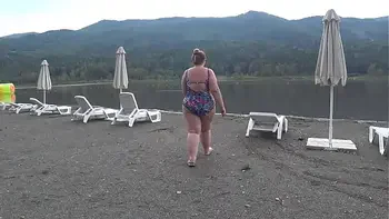 BBW with big booty in tight jeans is dressing in a public dressing room on the beach. Fetish.