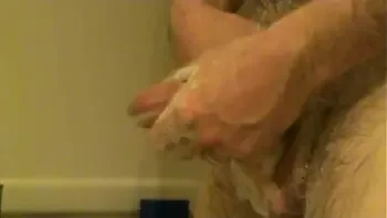 Hubby washing beautiful cock in the shower and it went off