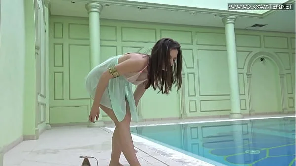 Sexiest petite teen Lizi Vogue swims naked in the pool
