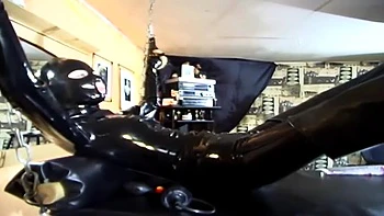 Humiliating chaining body stretching in latex dress