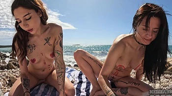Two sexy brunettes playing on the beach with no limits
