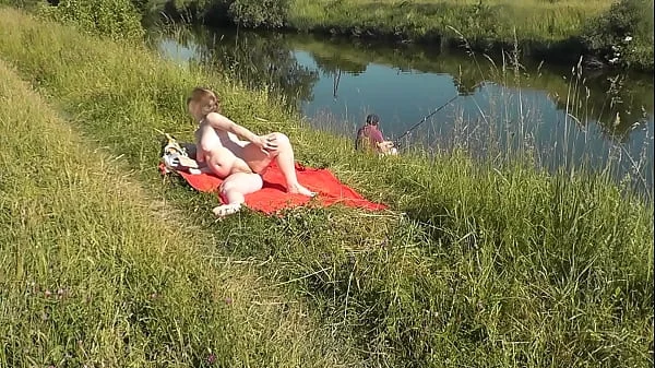 MILF sexy Frina on river bank undressed and sunbathes naked. Random man fisherman watching for her, and in the end decided to join naked woman. Wild beach. Nudist beach. Public nudity. Public exposure. Naked in public