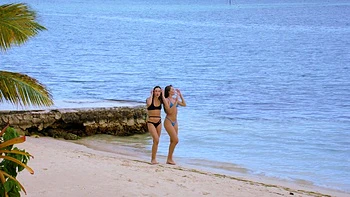 Naughty bikini-clad hotties indulge in a wild threesome by the ocean